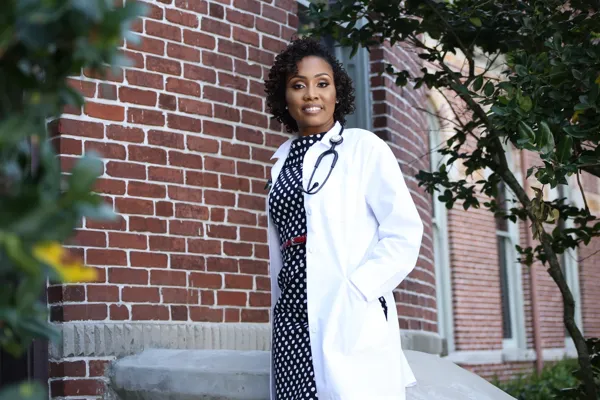 Nadia Barr in a white clinical coat